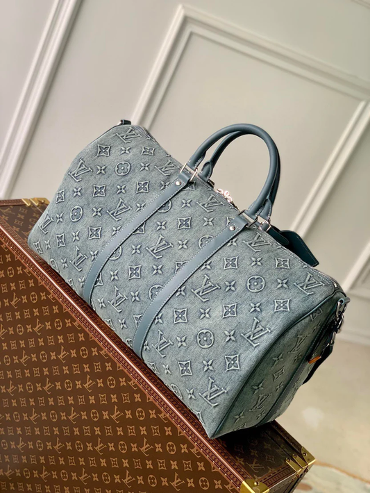 URBAN DENIM MONOGRAM EXPEDITION DUFFEL WITH EMBOSSED TEXTURE AND AZURE LEATHER TRIM