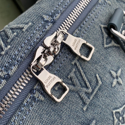 URBAN DENIM MONOGRAM EXPEDITION DUFFEL WITH EMBOSSED TEXTURE AND AZURE LEATHER TRIM