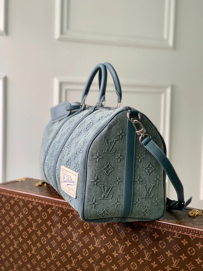 URBAN DENIM MONOGRAM EXPEDITION DUFFEL WITH EMBOSSED TEXTURE AND AZURE LEATHER TRIM
